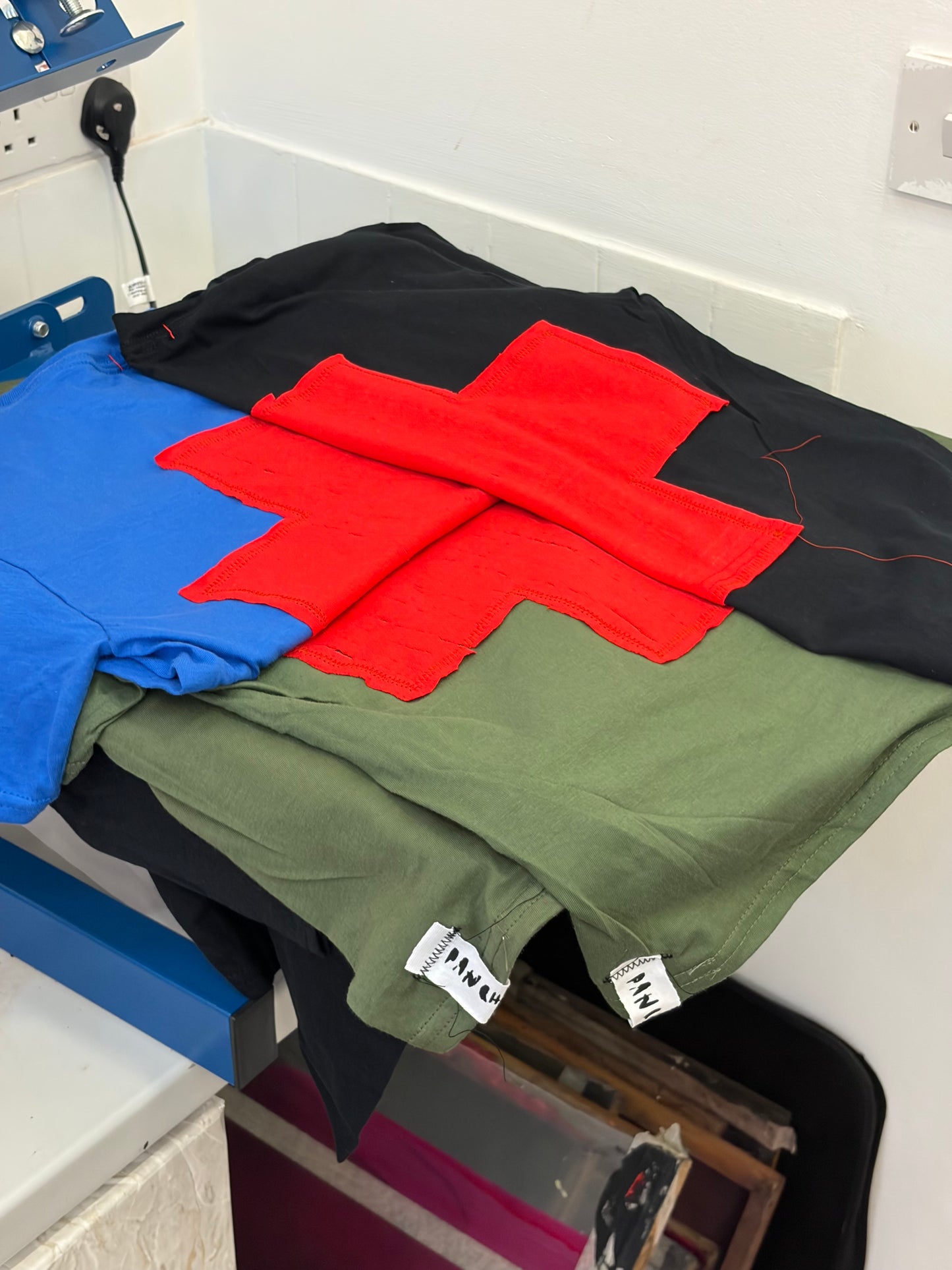 GREEN + RED CROSS BABY TEE