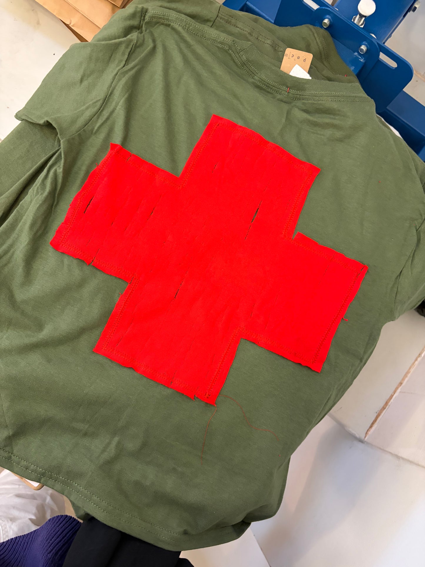 GREEN + RED CROSS BABY TEE